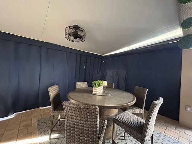 Navy blue curtains blocking afternoon sun in dining area