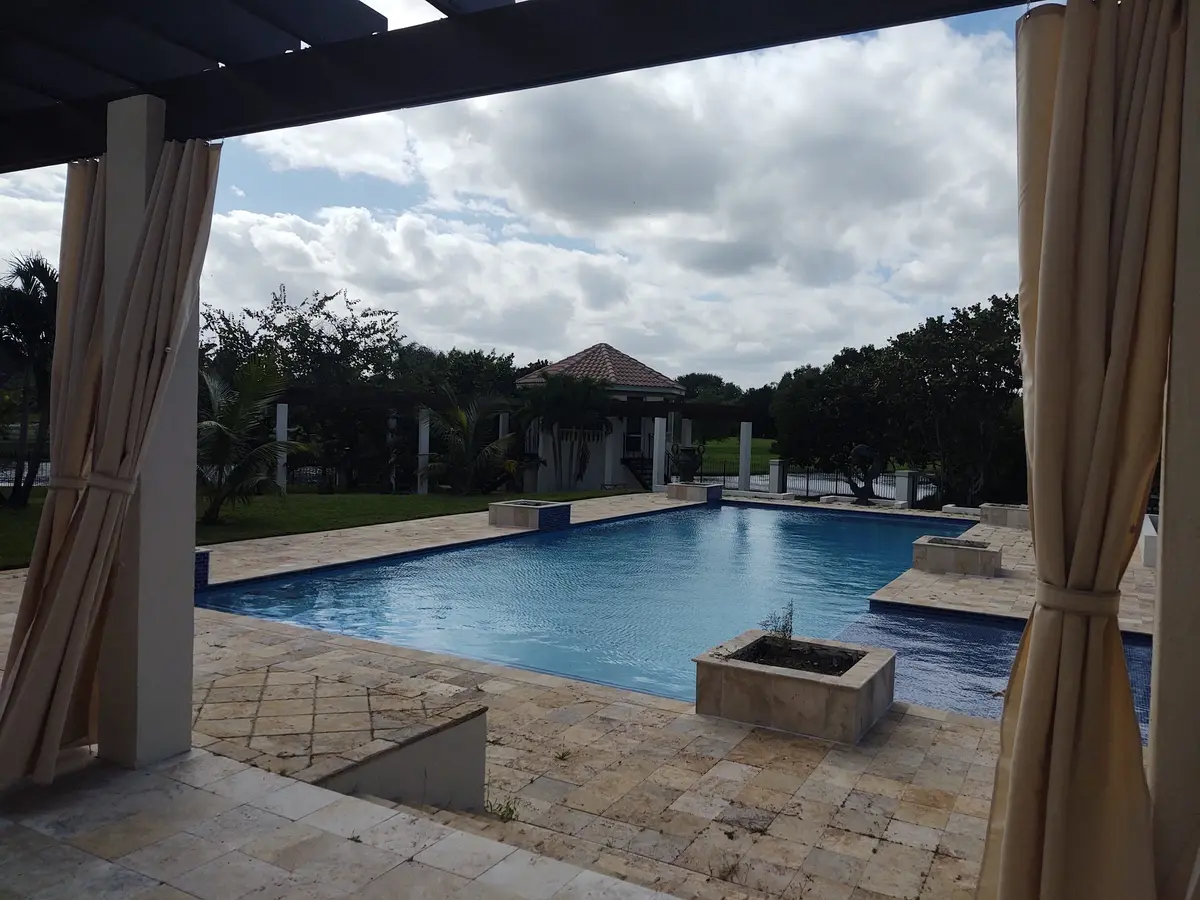 Beige curtains framing pool view