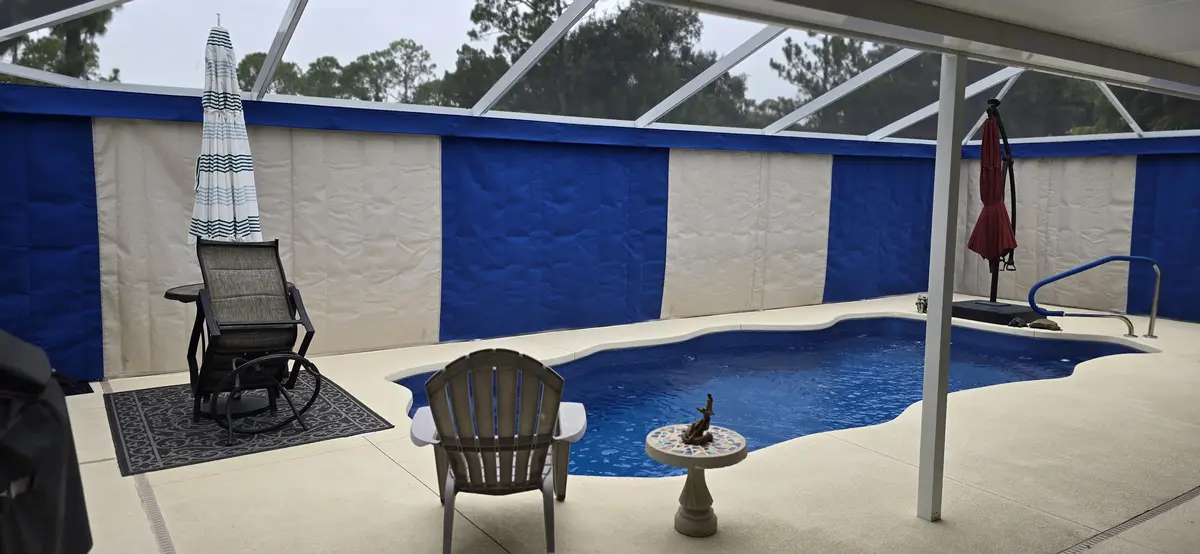 Blue and cream curtains around pool