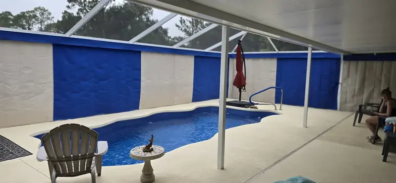 Blue and white Sunbrella privacy curtains around Orlando pool enclosure