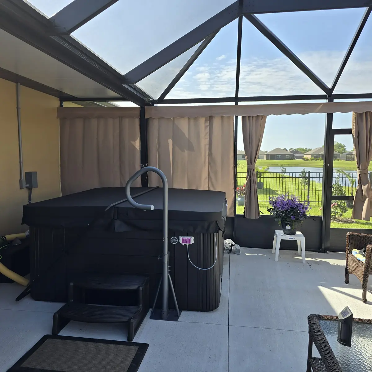 Tan privacy curtains in lanai with hot tub