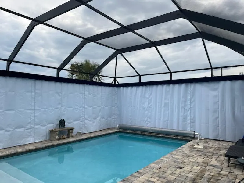 White Sunbrella lanai curtains around pool in Clermont FL screen enclosure