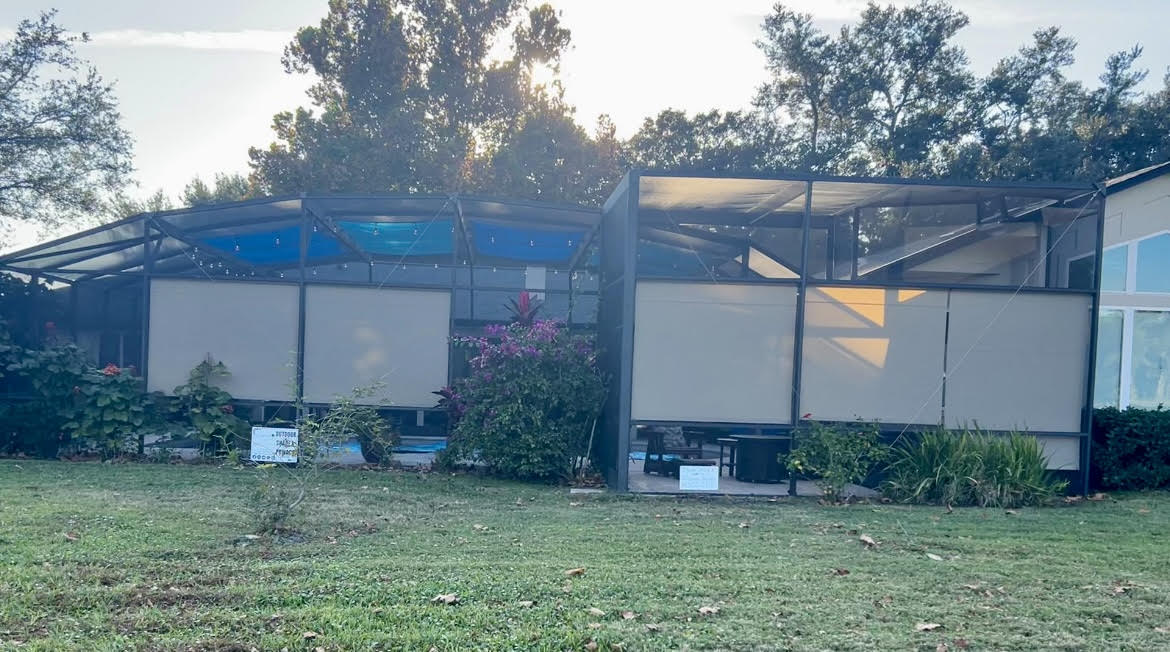 Roller shades and shade sails combination on pool enclosure exterior