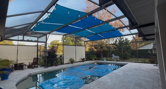 Blue shade sails with white roller shades combination