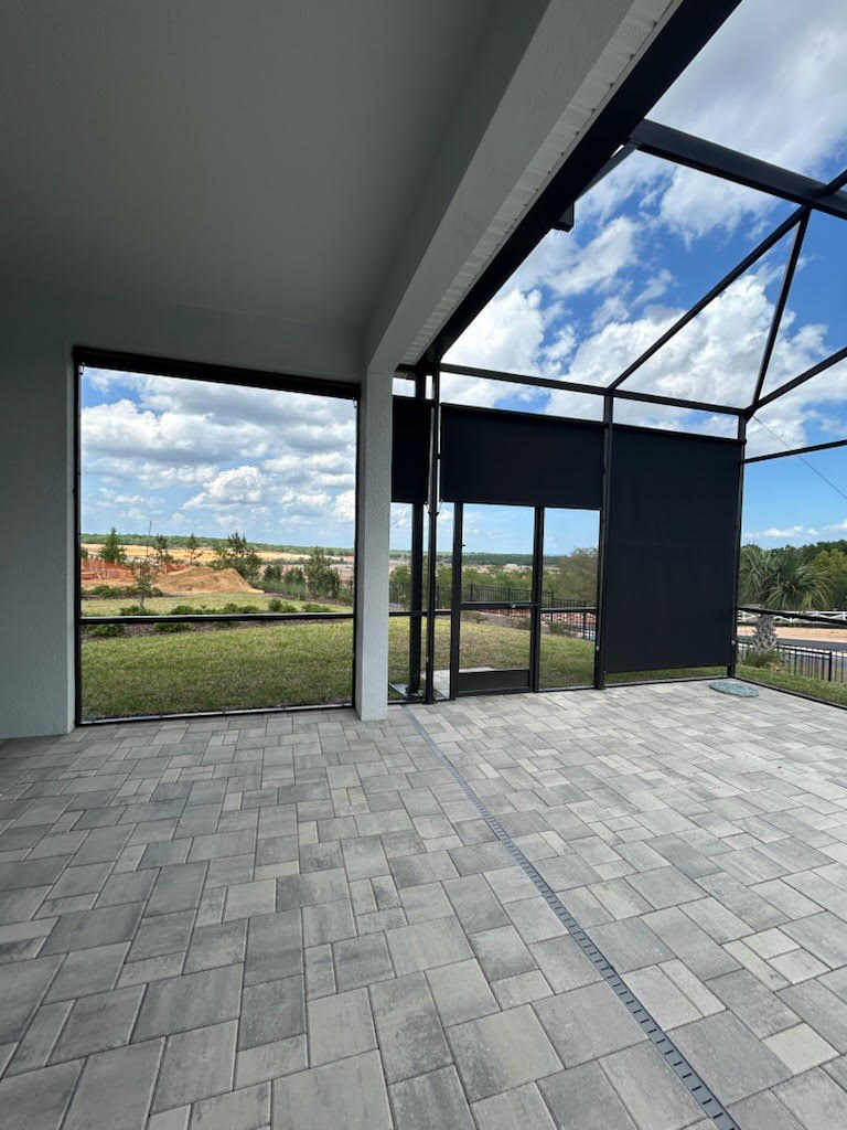 Charcoal roller shades on lanai with scenic view