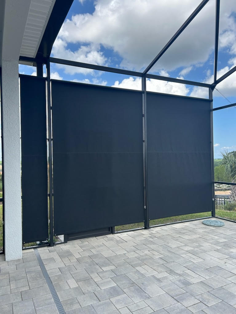 Charcoal roller shades on patio enclosure