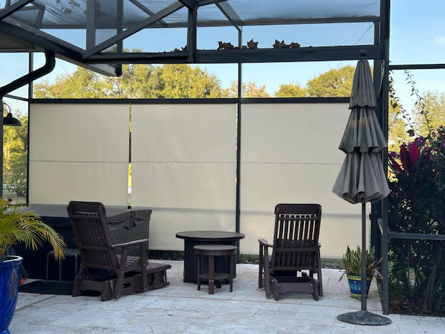 Cream roller shades on lanai with Adirondack chairs