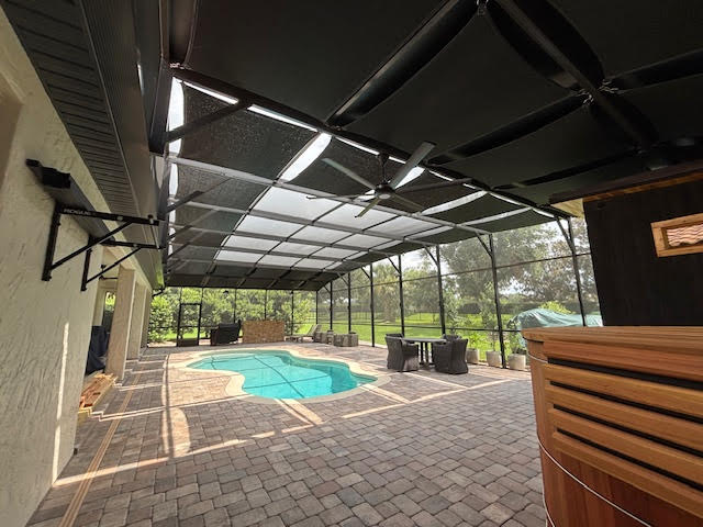 Black shade panels over pool enclosure