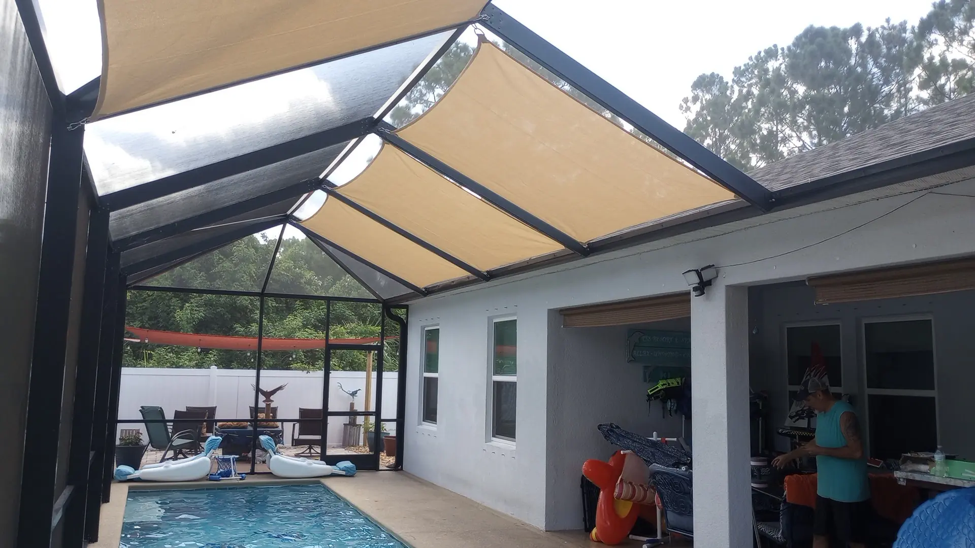 Gray shade sail panels in pool enclosure